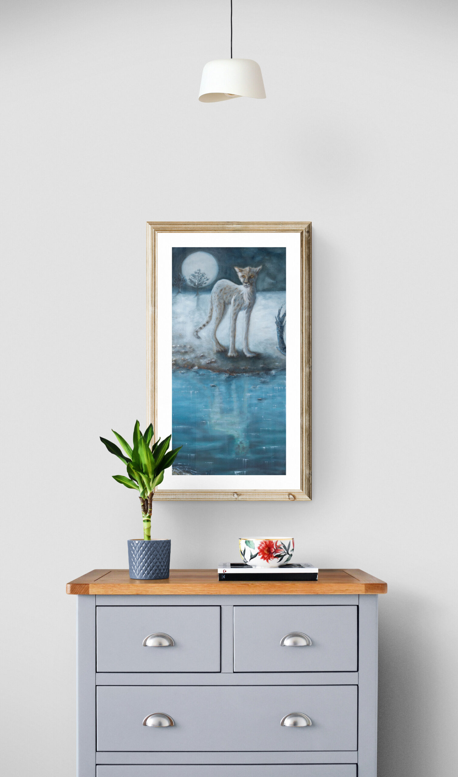 Cheetah standing at a waterhole by night